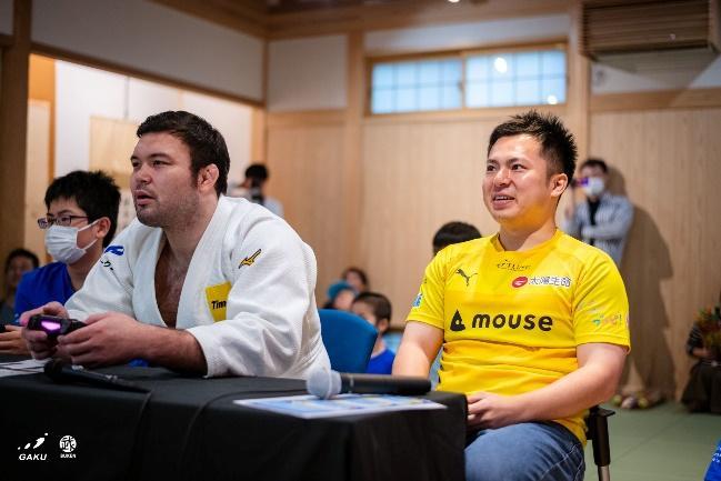 Olympian Aaron Wolf playing Puyo Puyo beside an esports athlete during GAKU Games Esports x Judo