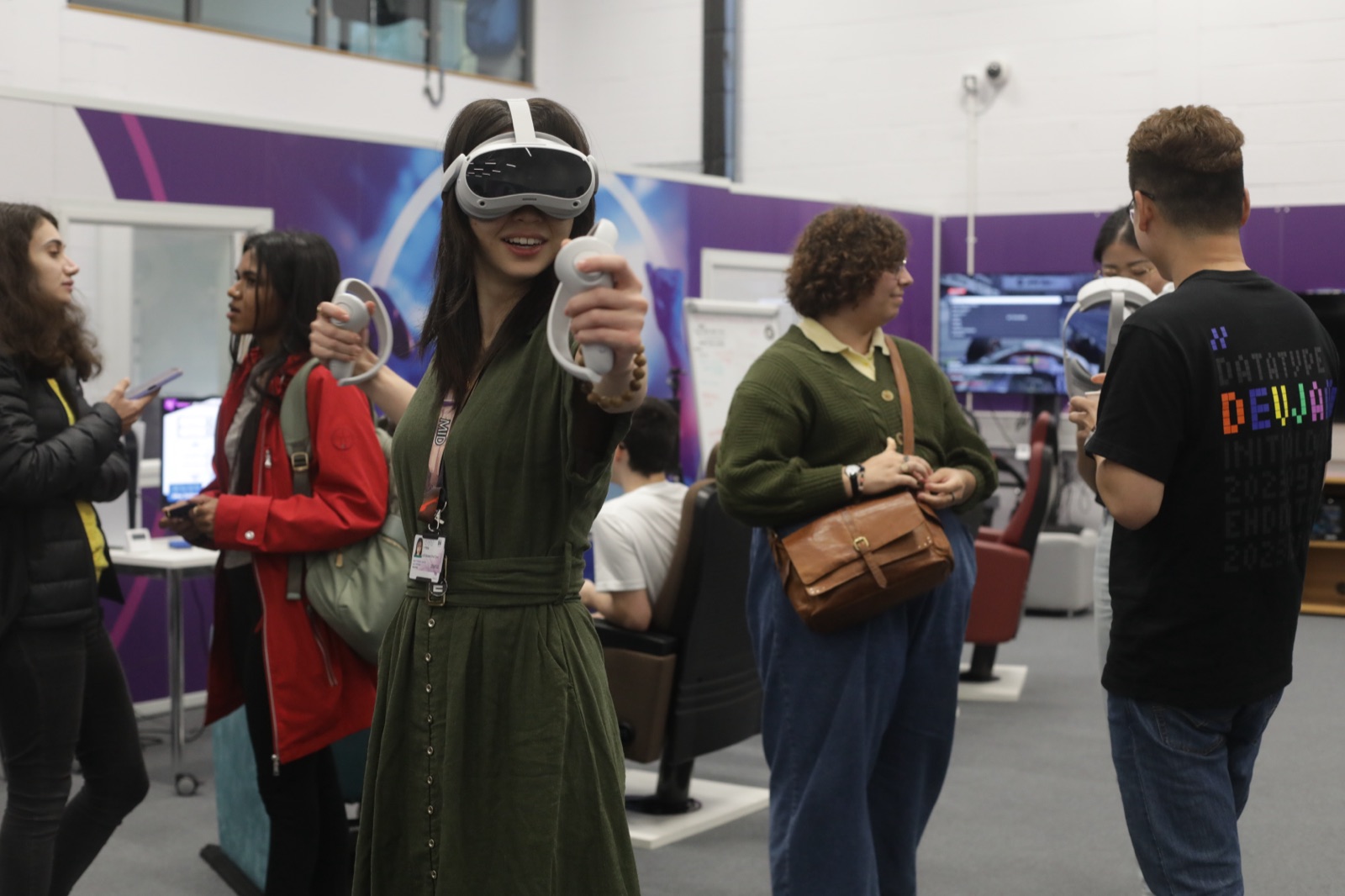 A university student trying a PICO VR headset at a GAKU Dev Jam session in a UK university lab